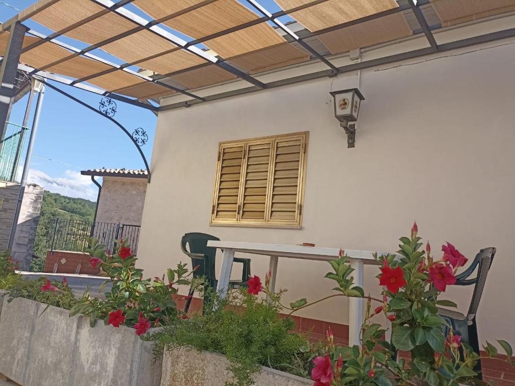 a patio with a table and chairs on a house at Bed&Bike Zio Paolino in Caramanico Terme