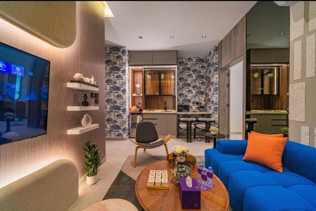 a living room with a blue couch and a table at SADEN Al-Salama in Jeddah