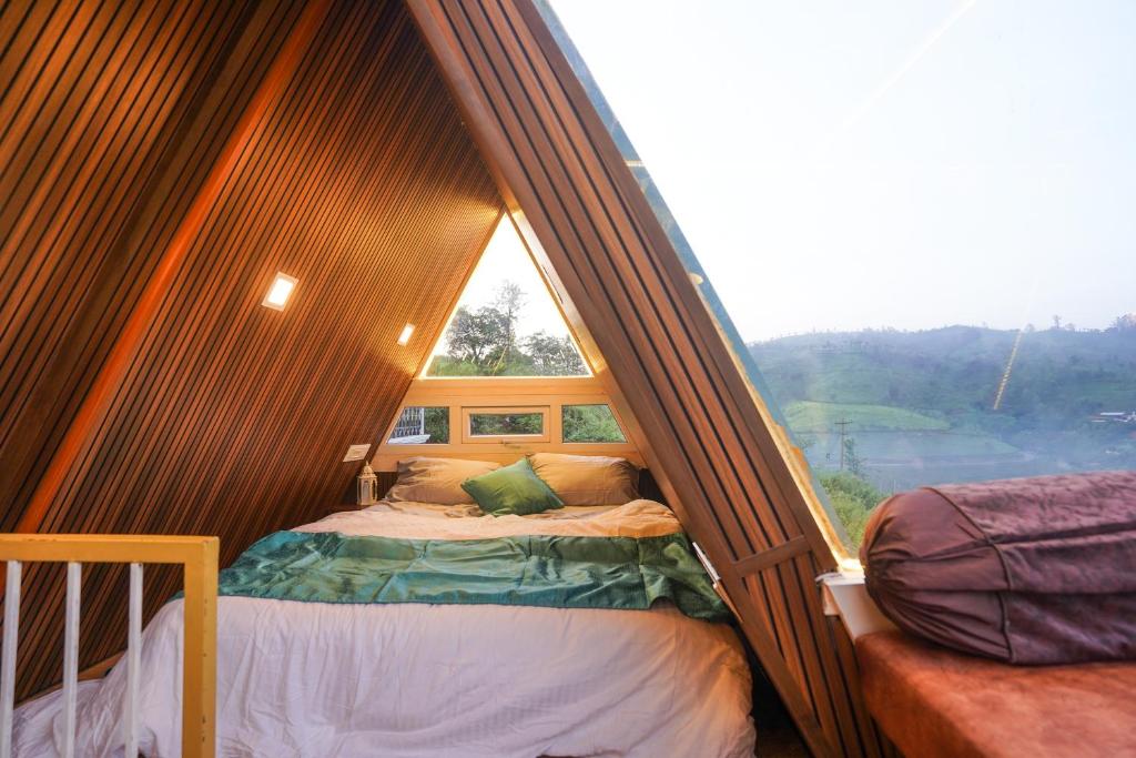 a bedroom with a bed in a room with a window at Casa de Selas - A Chalet Stay in Coonoor