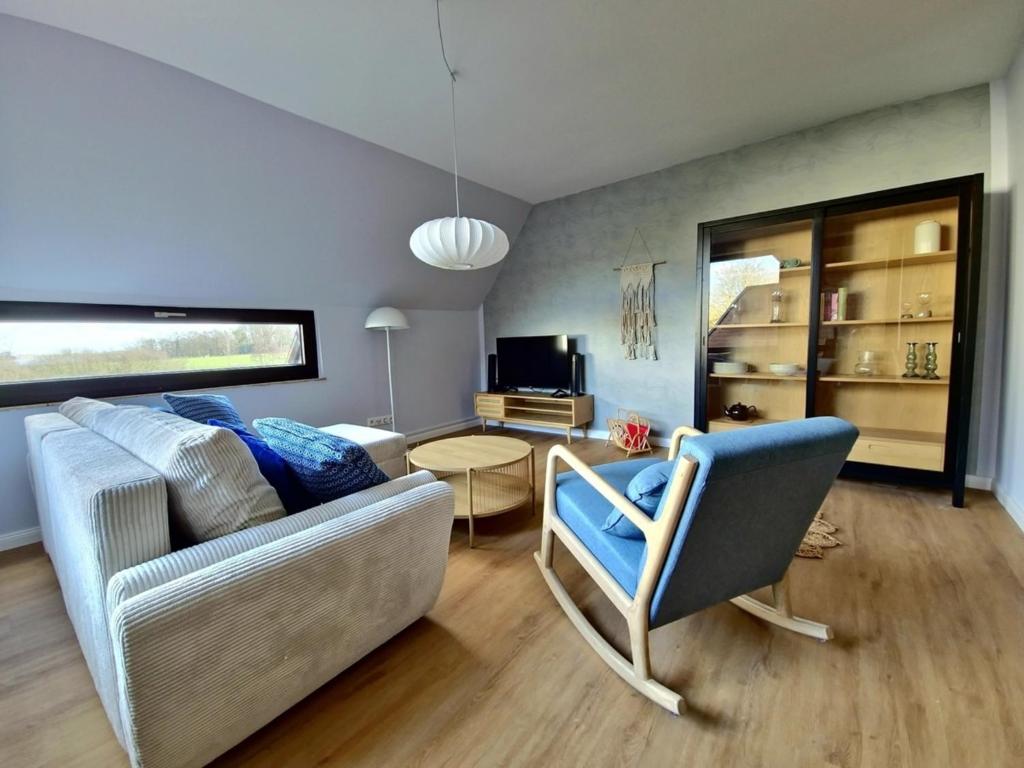 a living room with a couch and a chair at Ferienwohnung am See "Stella" in Bad Zwischenahn