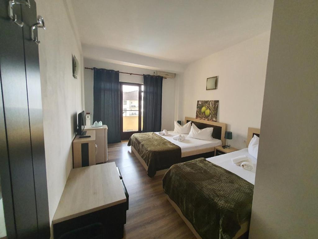 En eller flere senge i et værelse på Vila EPIC