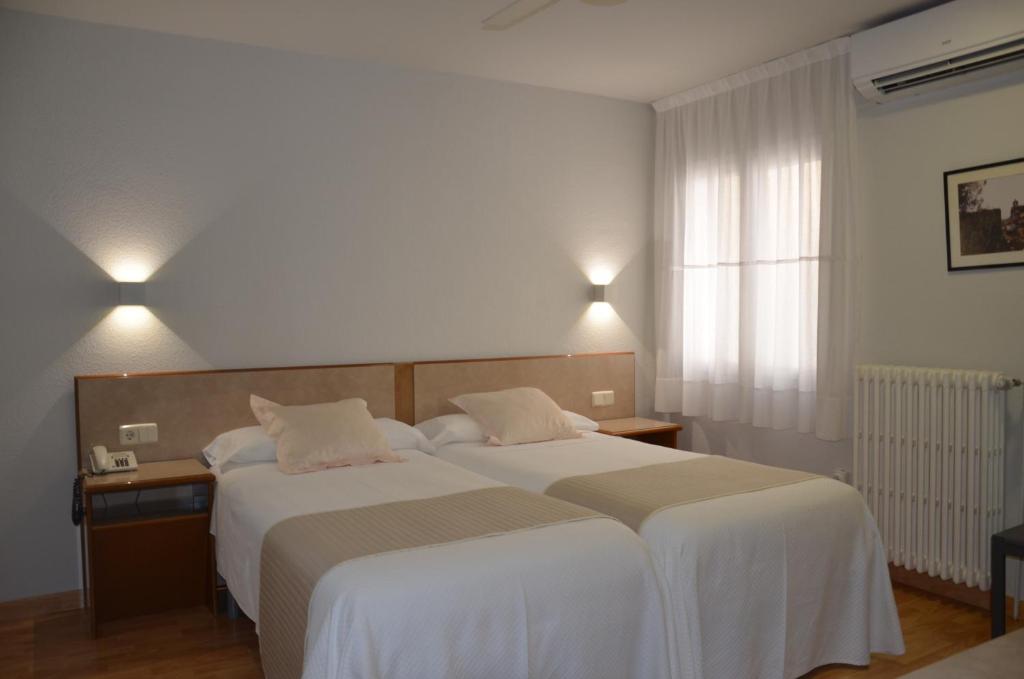 Postel nebo postele na pokoji v ubytování Hotel Balaguer