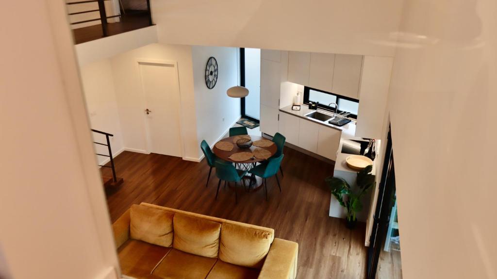 a view of a living room with a table and a couch at Oak Retreat House in Lagoa
