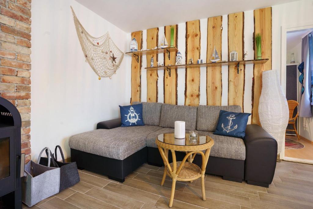 a living room with a couch and a table at Bungalow Karsten in Kamminke