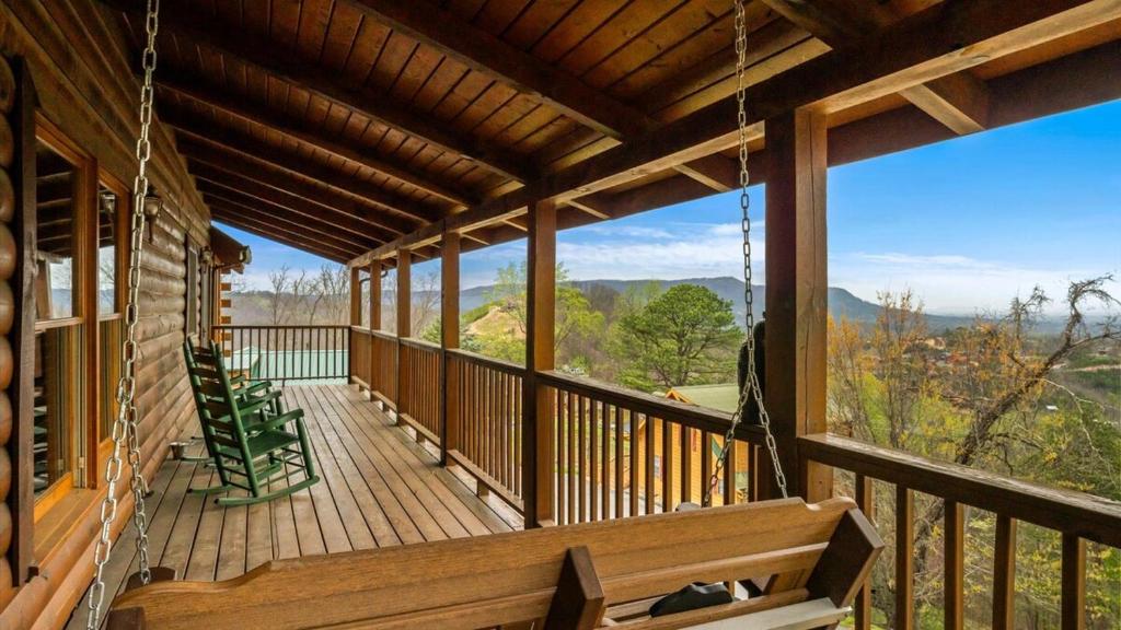 a porch of a cabin with a view of the mountains at Cozy Black Bear Cabin porch swing & stunning views in Sevierville
