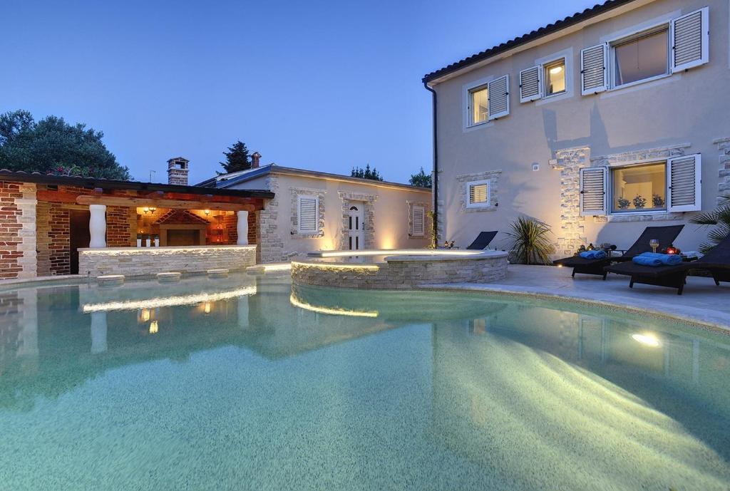 a swimming pool in front of a house at Villa Sonja in Medulin