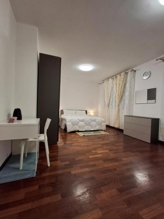 a bedroom with a bed and a desk and a table at cà venice tour vaction in Mestre