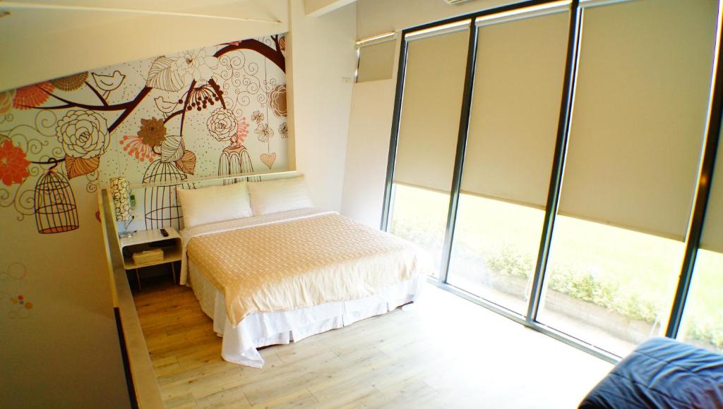 מיטה או מיטות בחדר ב-Lan Yang Resort Four Seasons