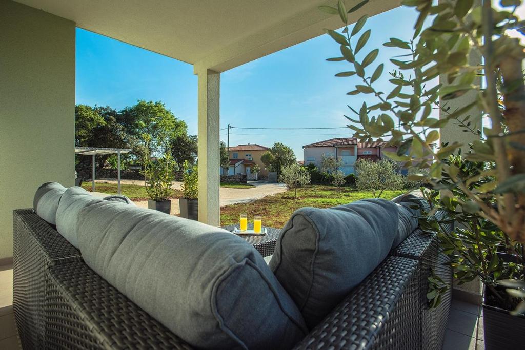 a couch with pillows on a patio at House Bellissima in Vodnjan