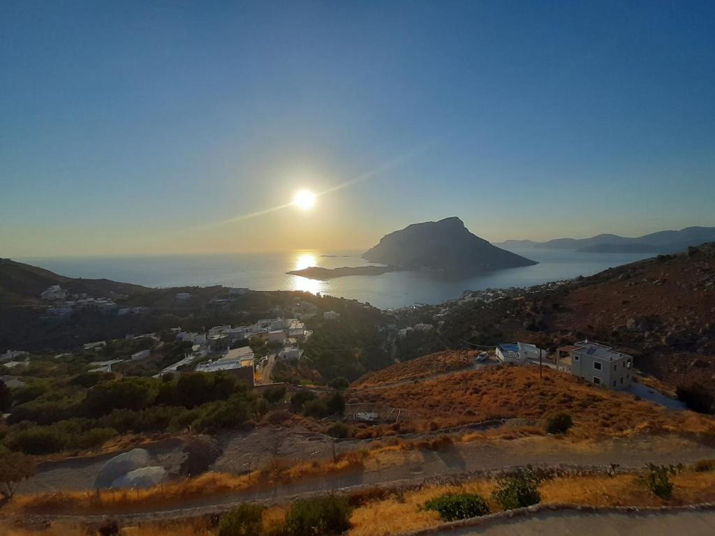 a view of the sun setting over the ocean at Symbligates rocks in Kalymnos