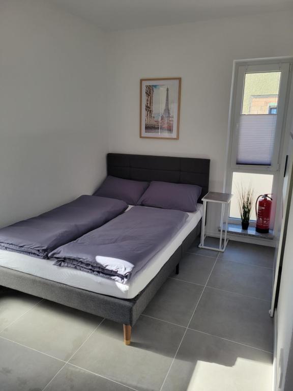 a bed with purple sheets in a bedroom at Ferienwohnung Esen EG in Günzburg