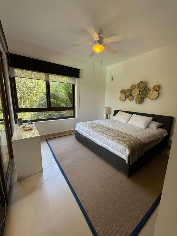 a bedroom with a bed and a ceiling fan at Selva Tulum - HiveNB in Tulum