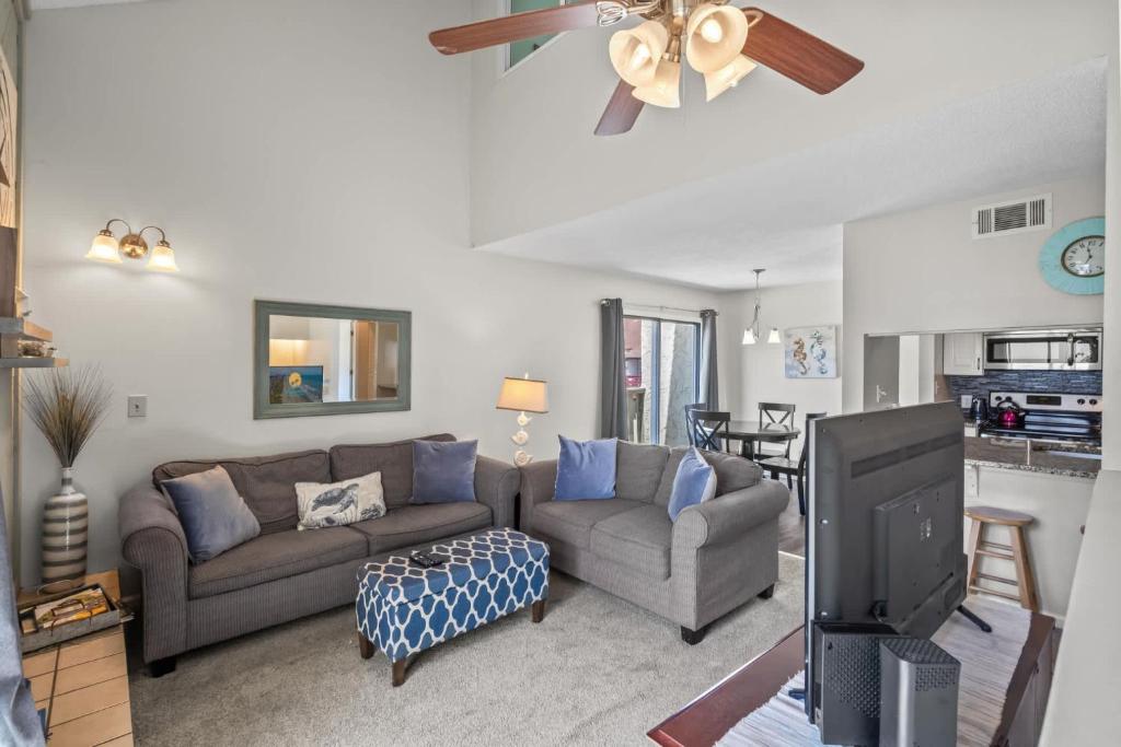 a living room with a couch and a tv at Brandywine Unit 203 in Myrtle Beach