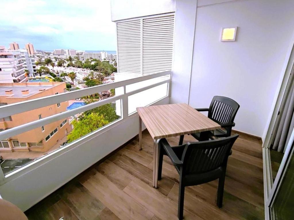 a table and two chairs on a balcony with a view at Sea views Estudio Ponderosa near the beach in Costa de Adeje