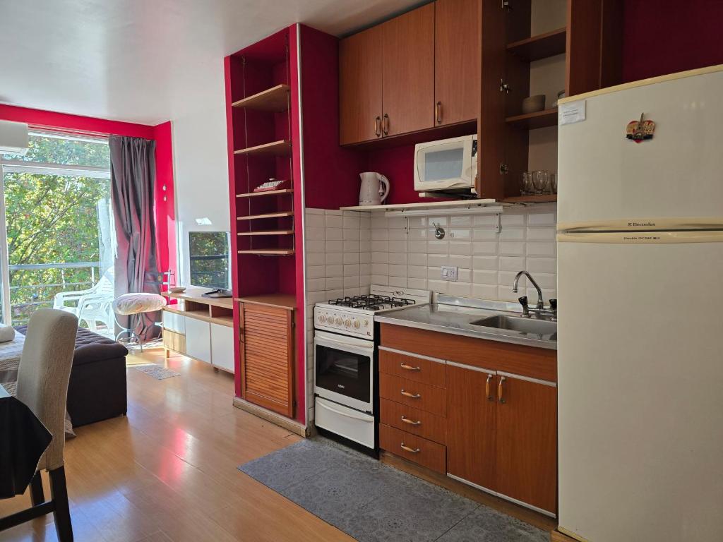a kitchen with a white refrigerator and a sink at Luz Urbana BA Studio in Buenos Aires