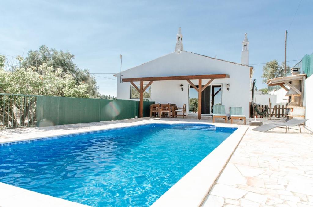 a swimming pool in a yard with a gazebo at Casa da Serra - Moradia T2 in Montes Novos