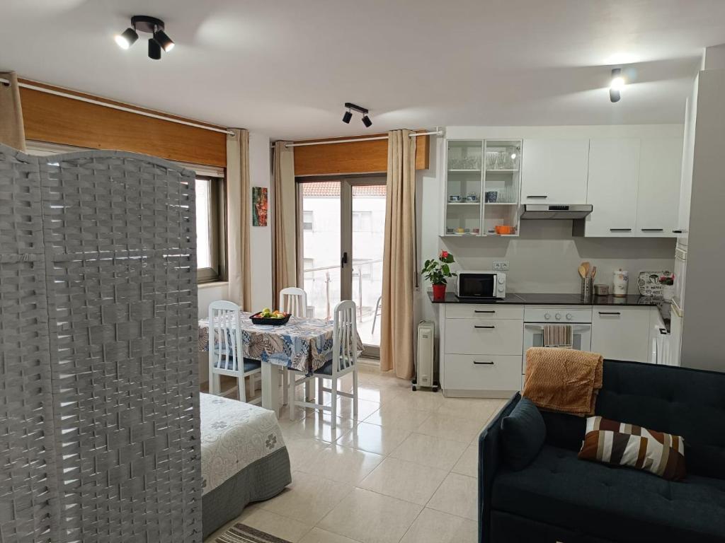 a kitchen and living room with a couch and a table at Estudio Centro A Guarda in A Guarda