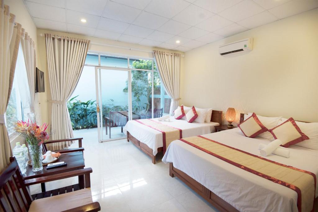 Giường trong phòng chung tại Sunlight Bungalow