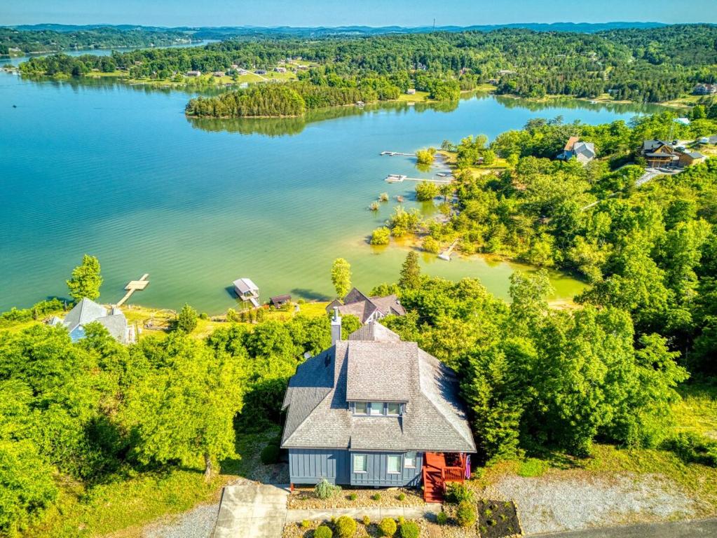 an aerial view of a house on the shore of a lake at Lake View Cabin Incredible Panoramic Views, Spa in Sevierville