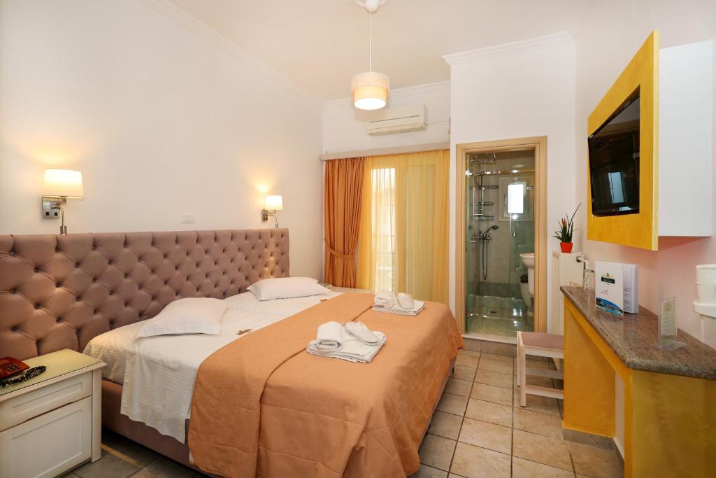 Postel nebo postele na pokoji v ubytování Hotel Klonos - Kyriakos Klonos