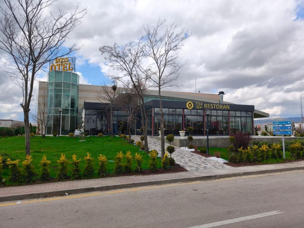 a building with a bunch of flowers in front of it at Boss Otel Kahramankazan in Kışlaköy