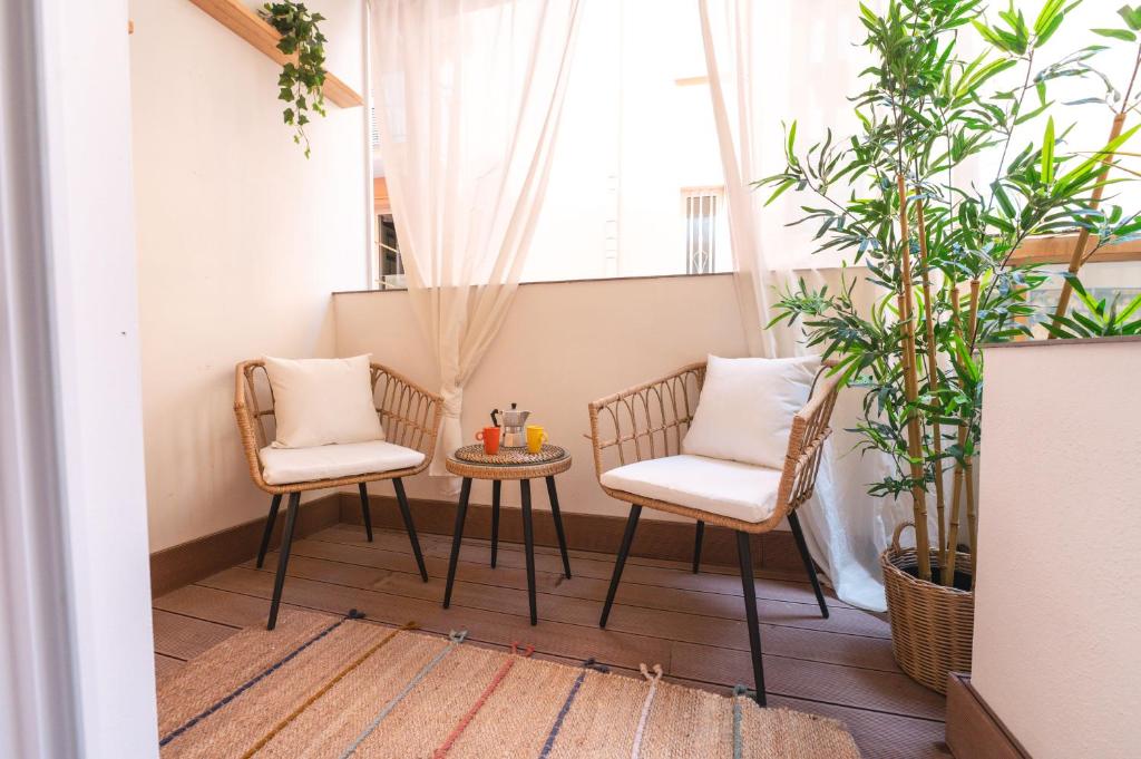 a small balcony with two chairs and a table at Santa Caterina Apartment in Varazze