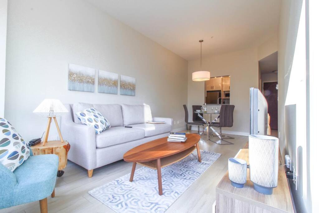 a living room with a couch and a table at Beautiful Downtown Unit in Vancouver