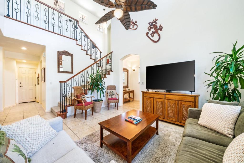 a living room with a couch and a flat screen tv at Big Island Fairways at Mauna Lani 1701 by Coldwell Banker Island Vacations in Waikoloa