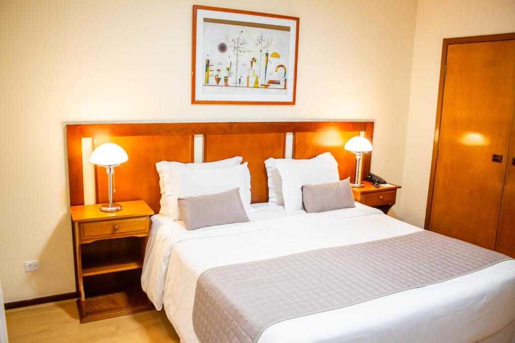 Postel nebo postele na pokoji v ubytování Radio Hotel Resort & Convention
