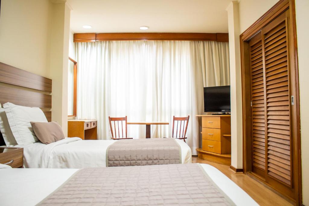 Postel nebo postele na pokoji v ubytování Radio Hotel Resort & Convention