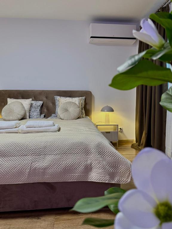 a bedroom with a large bed with pillows at DeLuxury Apartment Chmielna in Warsaw