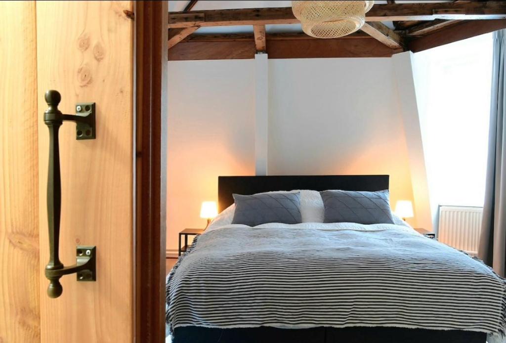 a bedroom with a large bed with a wooden frame at Green City Apartement in Alkmaar