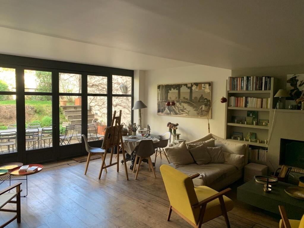 a living room with a couch and a table at Country house in Paris in Boulogne-Billancourt