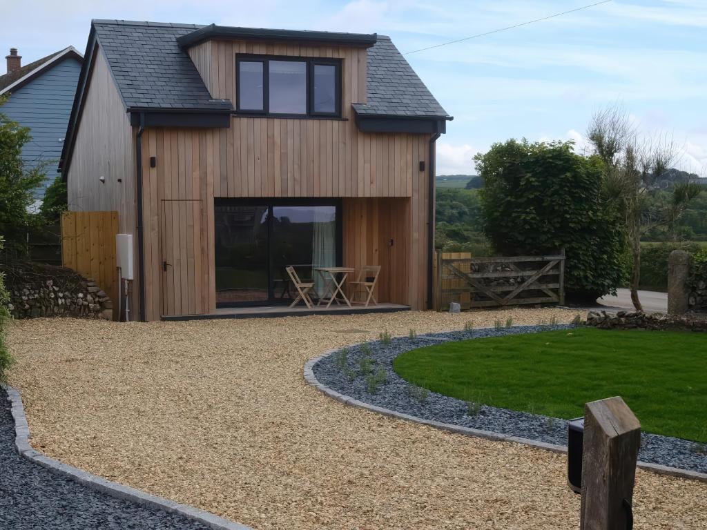 a house with a patio and a lawn at The Cabin at Ropewalk in St. Agnes