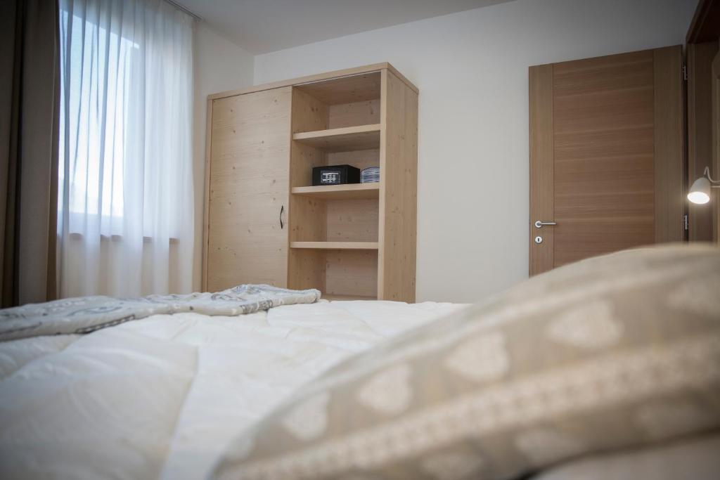 Postel nebo postele na pokoji v ubytování Aparthotel Dolomites Living&Relax