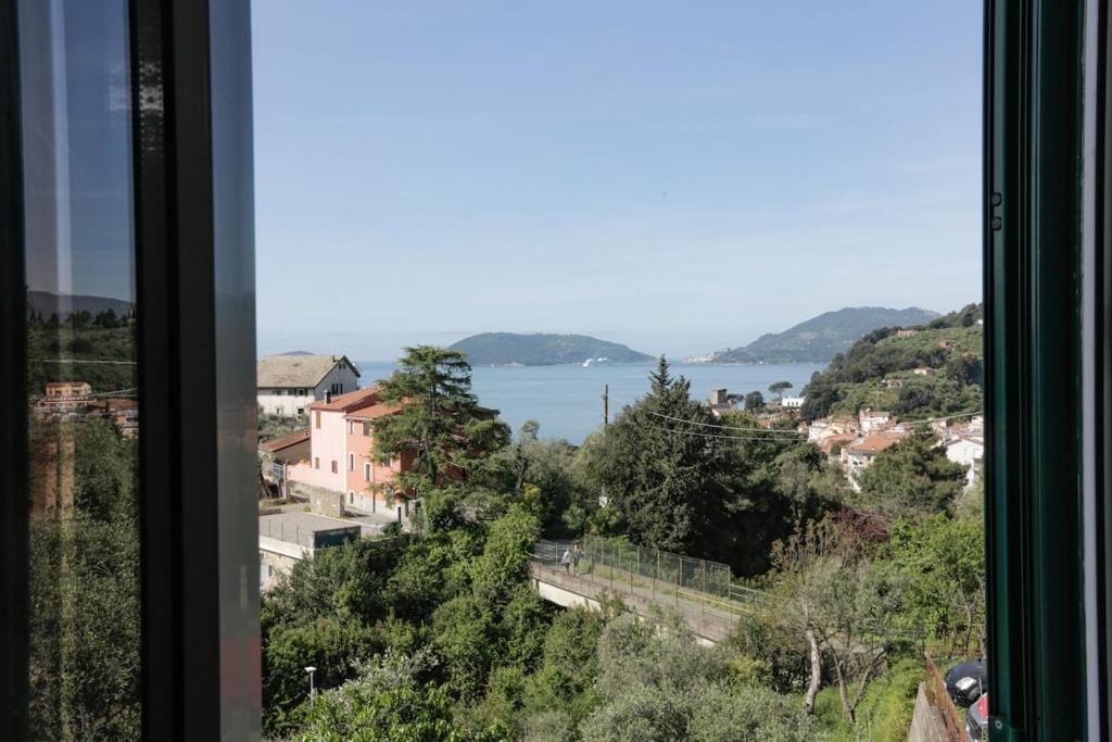 a view from a window of a city and a lake at Casa Storica a San Terenzo in San Terenzo