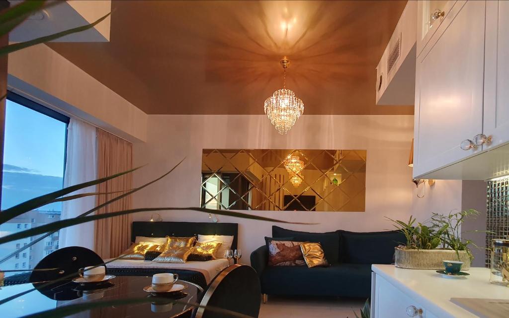 a living room with a bed and a couch at Diamond class 2 Hanza Tower in Szczecin