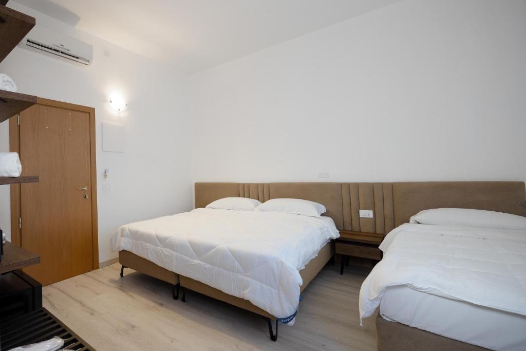 Postel nebo postele na pokoji v ubytování Hotel Levante Cesenatico