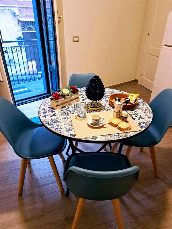 a table with chairs and a table with food on it at Casaparrinello Maletto Concy in Maletto