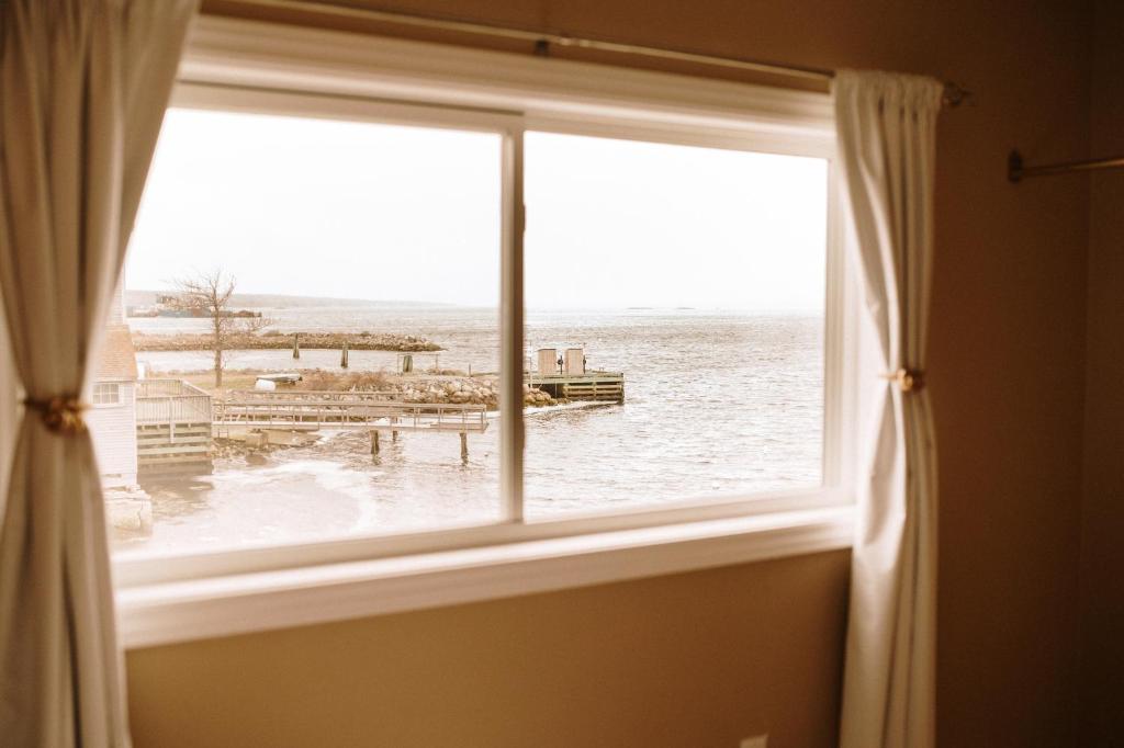 a window with a view of a body of water at Albert's in Shelburne