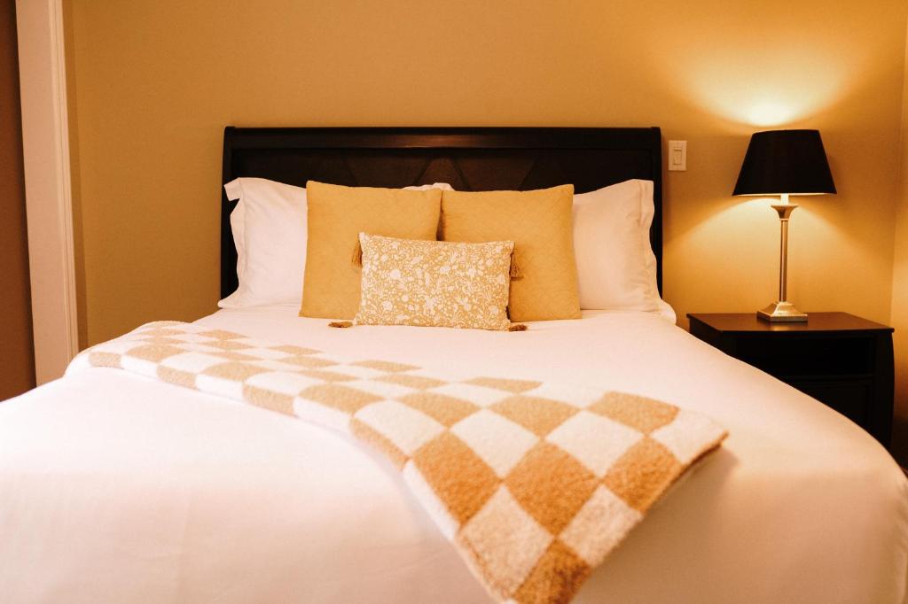 a bedroom with a large white bed with a pillow at Albert's in Shelburne
