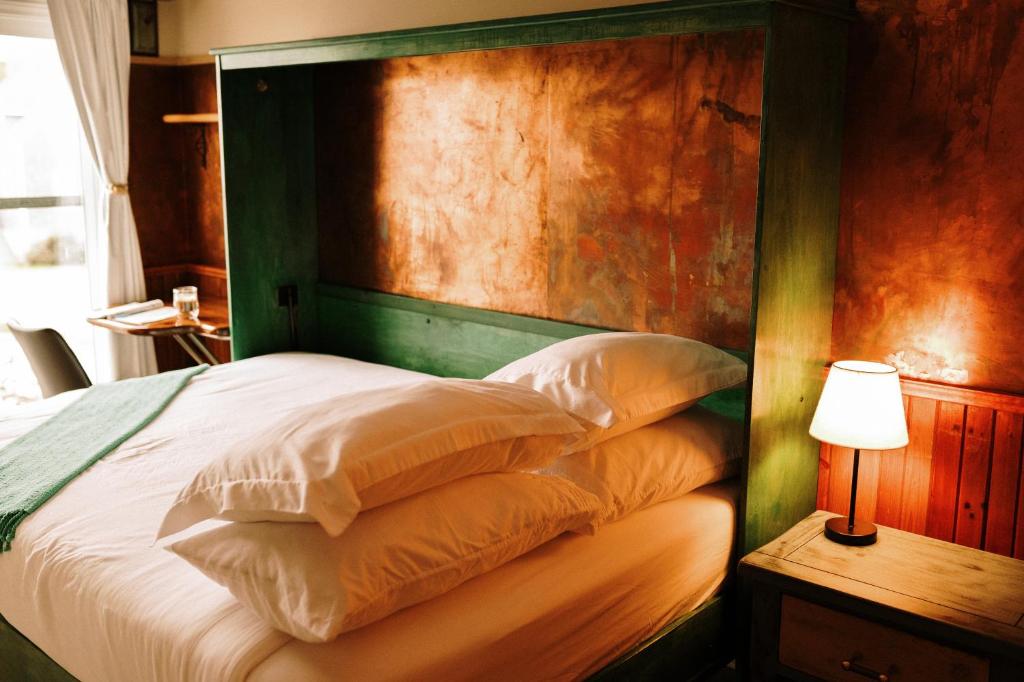 a bedroom with a large bed with a wooden headboard at Albert's in Shelburne