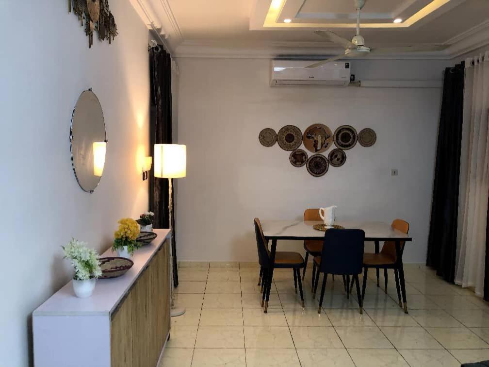 Un comedor con una mesa y algunas sillas. en Cozy Apartment near the GMK stadium, en Cotonou