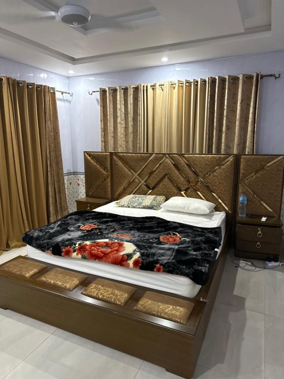 a bedroom with a large bed in a room at Nizami menzil house in Dargai