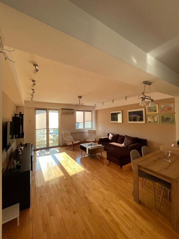 a living room with a couch and a table at Velvet Living Luxury Apartment in Skopje