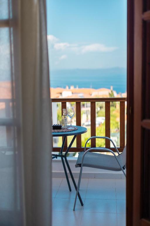 a table and a chair on a balcony at Horizon Studios Afitos in Afitos