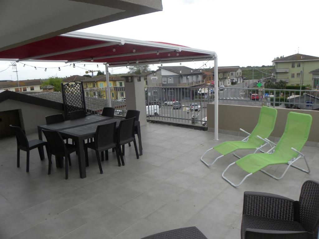 a patio with a table and chairs on a roof at Casa Cicolani in Scardovari