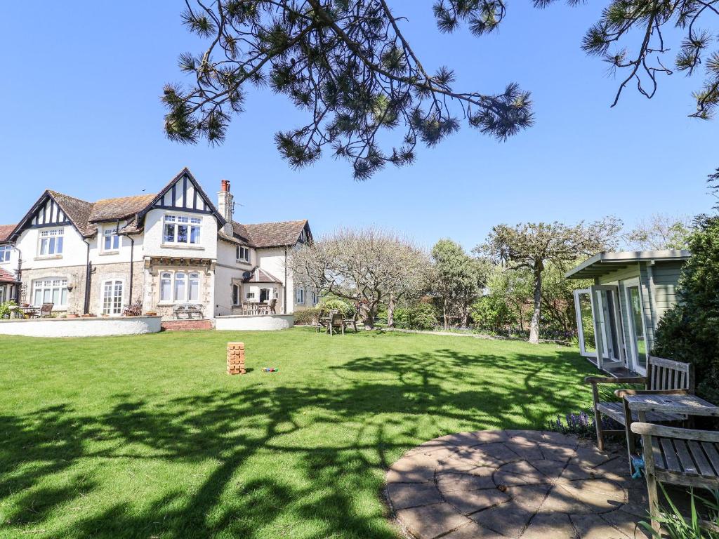 a large house with a large grass yard at The Seaside Inn in Seaton