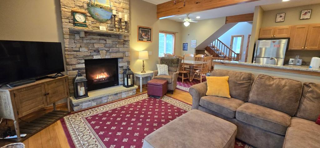 a living room with a couch and a fireplace at Our Heart's Desire- spacious 3 BR condo with hot tub in great location! in McHenry