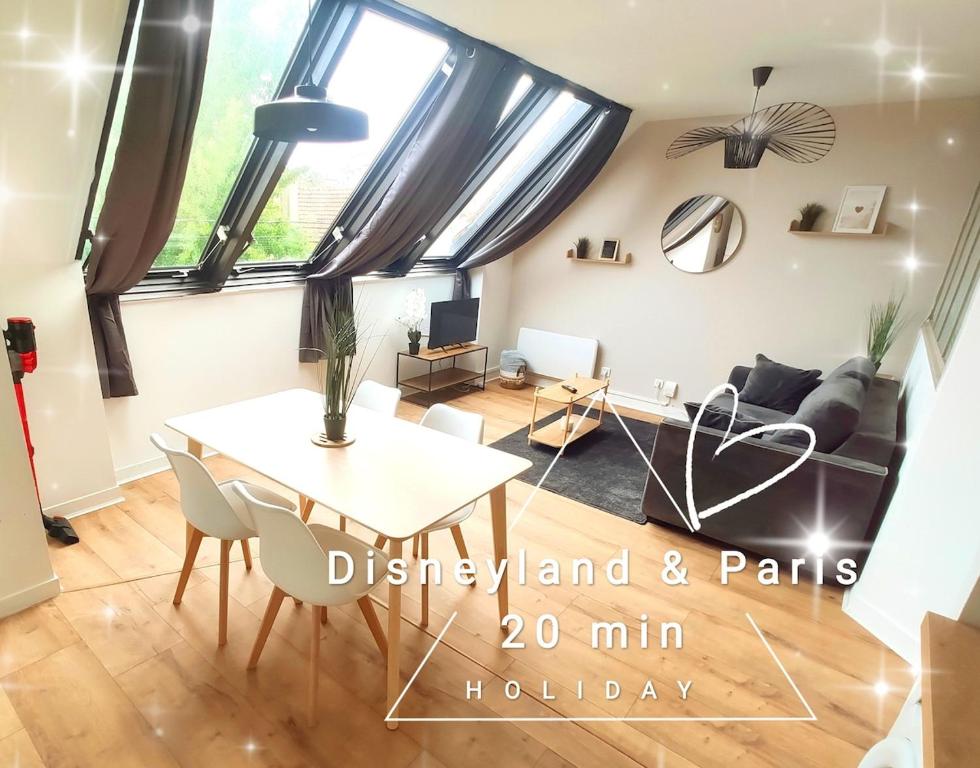 a living room with a table and a couch at DisneyLand - Paris 20 min - Parking - 6 personnes in Chelles